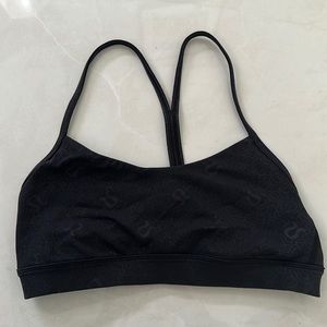 Lululemon flow y nulu sports bra. Black with lululemon pattern.